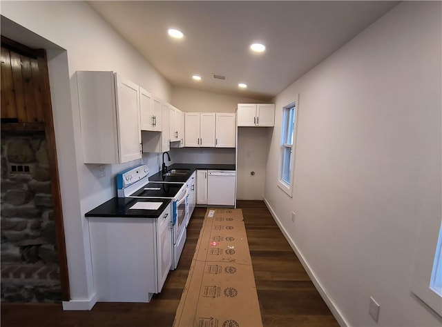 kitchen featuring white appliances, sink, white cabinets, dark hardwood / wood-style floors, and lofted ceiling