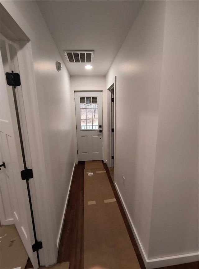 doorway with dark hardwood / wood-style flooring