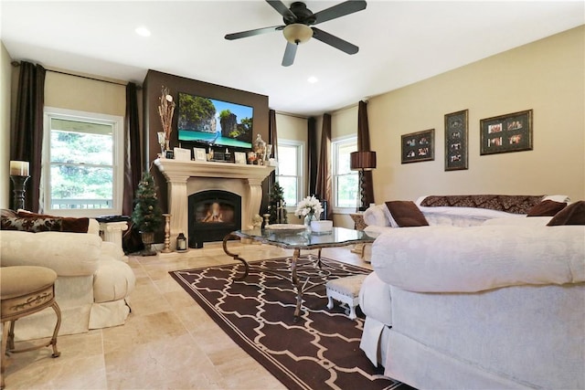 living room featuring ceiling fan and a healthy amount of sunlight