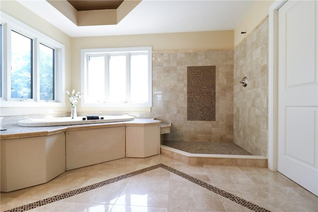 bathroom with tile patterned flooring and tiled shower