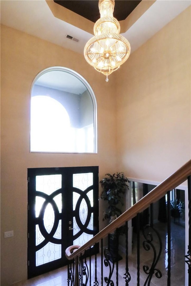 foyer with a healthy amount of sunlight and a notable chandelier