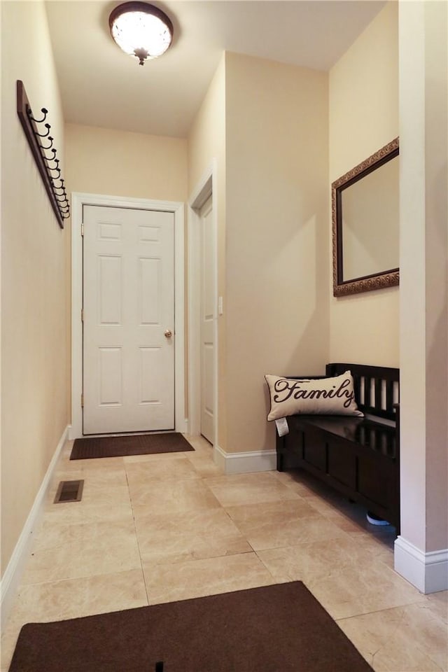 doorway to outside with light tile patterned floors