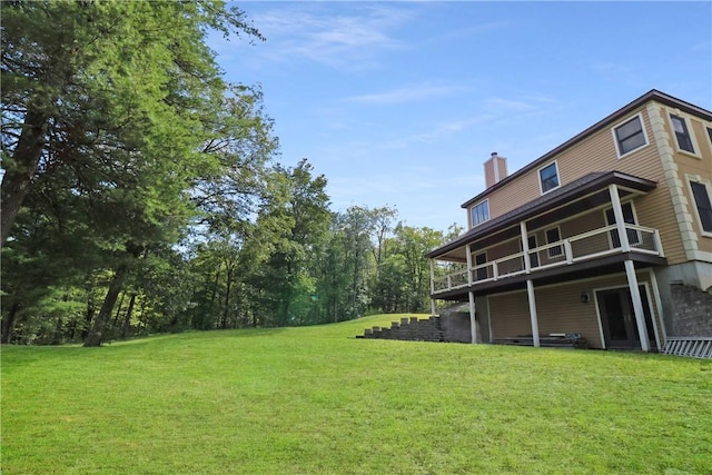 view of yard featuring a balcony