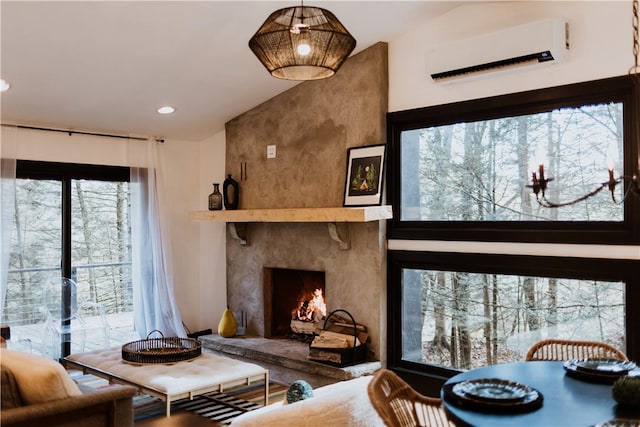 living room featuring a wall mounted air conditioner, lofted ceiling, and a high end fireplace