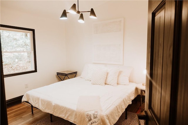 bedroom with hardwood / wood-style floors and ceiling fan