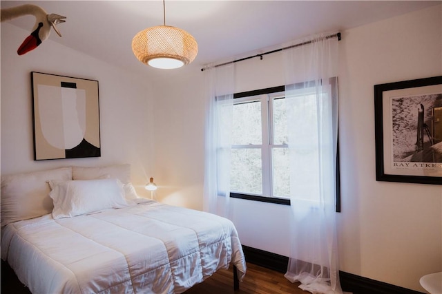 bedroom featuring hardwood / wood-style flooring and lofted ceiling