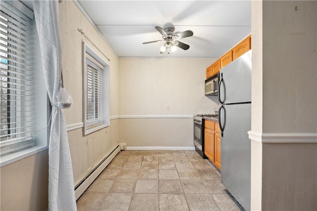 kitchen with ceiling fan, light brown cabinetry, a baseboard radiator, and appliances with stainless steel finishes