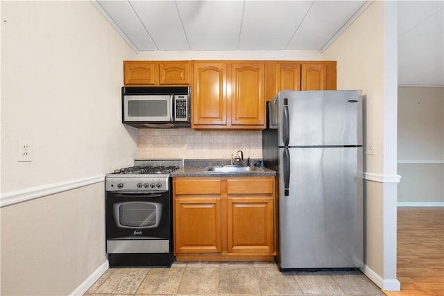 kitchen with decorative backsplash, sink, stainless steel appliances, and crown molding