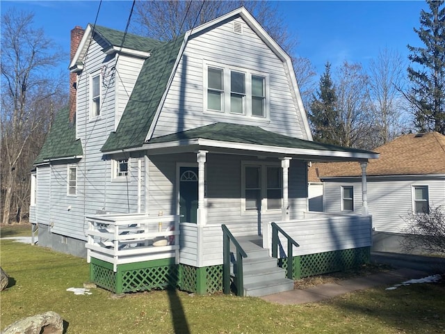 view of front of property featuring a front lawn and covered porch