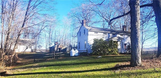 view of side of property with a yard