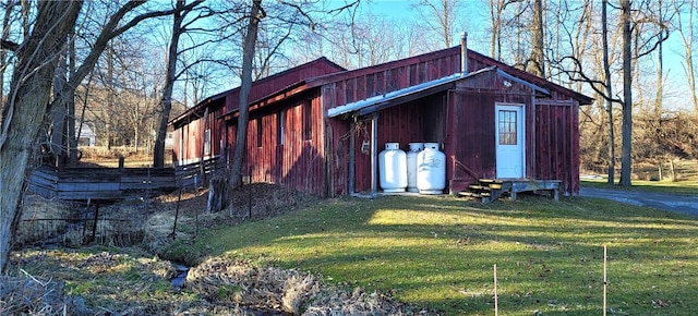 view of outbuilding with a lawn