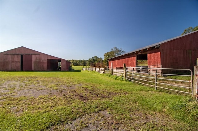 view of yard with a rural view and an outdoor structure