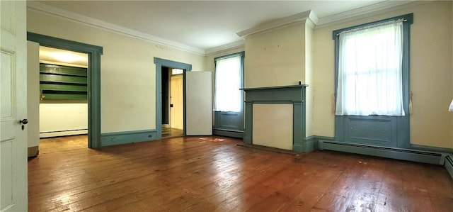 empty room featuring dark hardwood / wood-style floors, crown molding, and baseboard heating