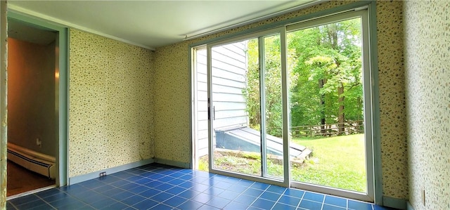 entryway featuring dark tile patterned flooring, plenty of natural light, and a baseboard radiator