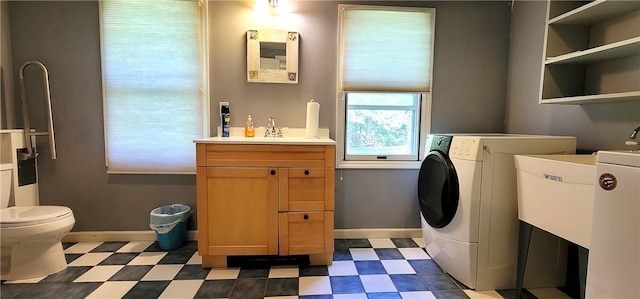 washroom with sink and washer / dryer