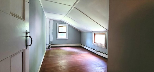 bonus room featuring baseboard heating, dark wood-type flooring, and vaulted ceiling