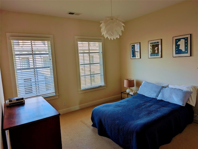 bedroom featuring light carpet, visible vents, and baseboards