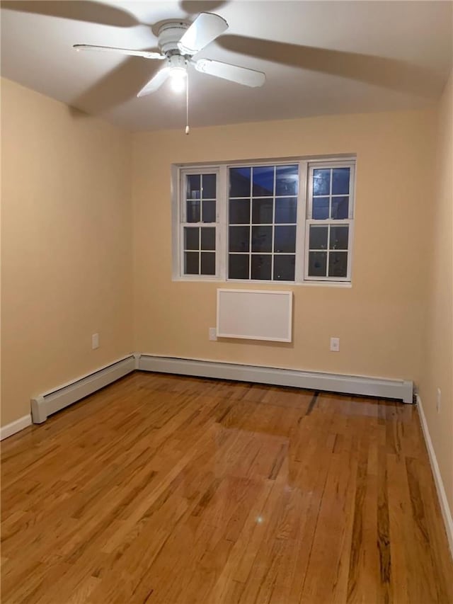 empty room featuring hardwood / wood-style floors and ceiling fan