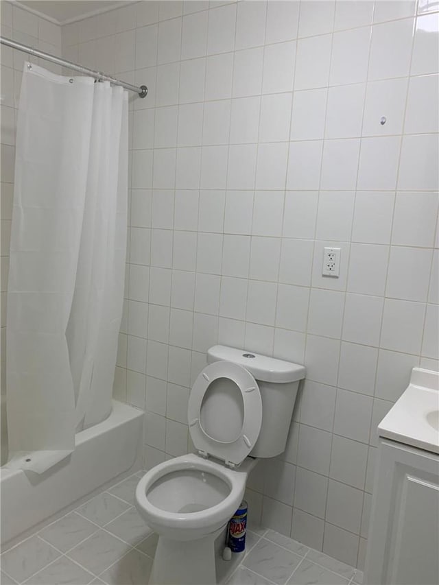 full bathroom featuring vanity, toilet, shower / bath combo with shower curtain, and tile walls