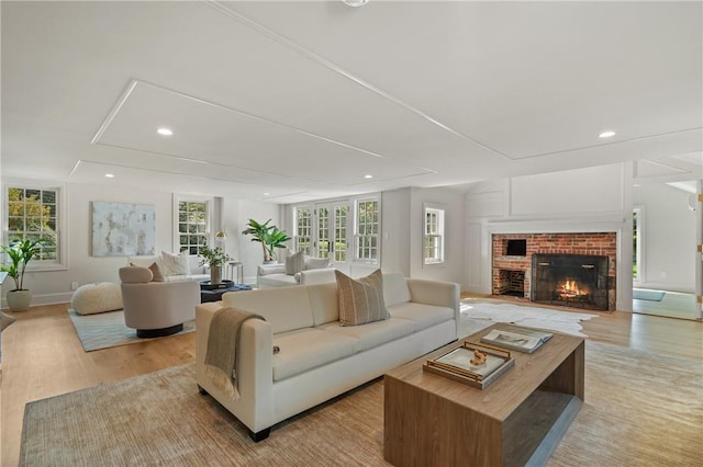 living room featuring a fireplace and light hardwood / wood-style flooring