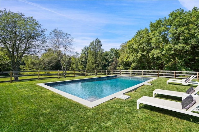 view of swimming pool with a yard