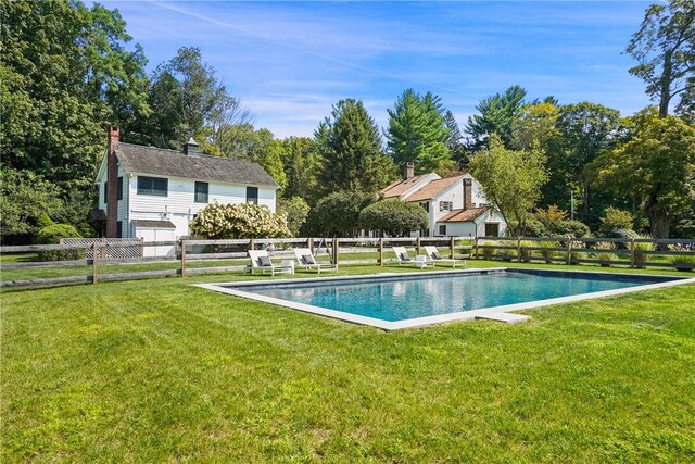 view of swimming pool featuring a lawn