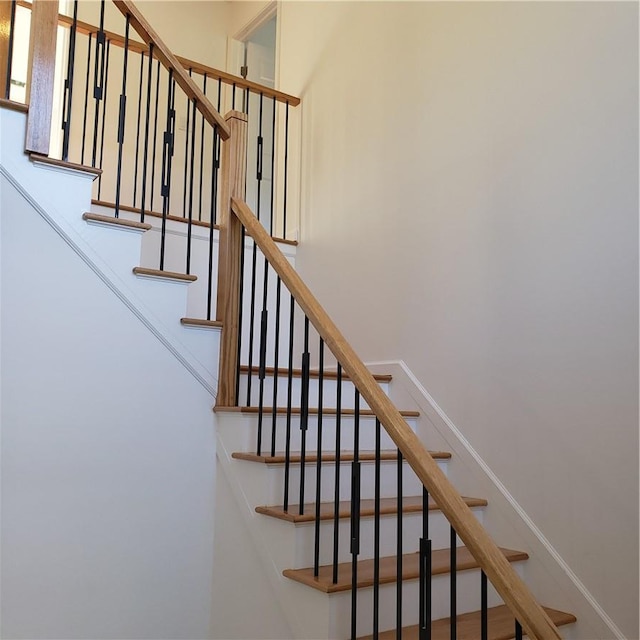 stairs featuring a towering ceiling