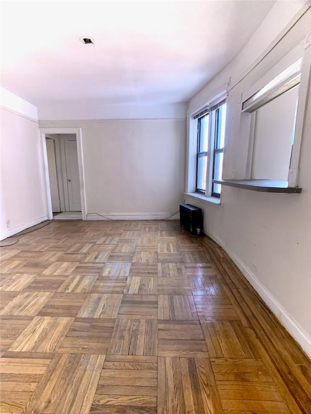 unfurnished room featuring parquet flooring