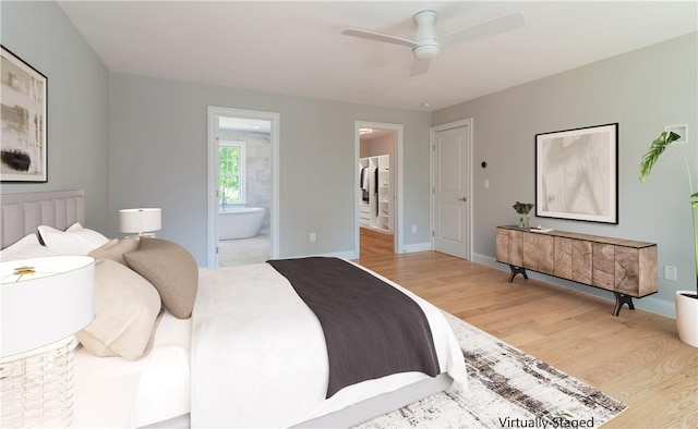 bedroom featuring ensuite bathroom, hardwood / wood-style floors, and ceiling fan