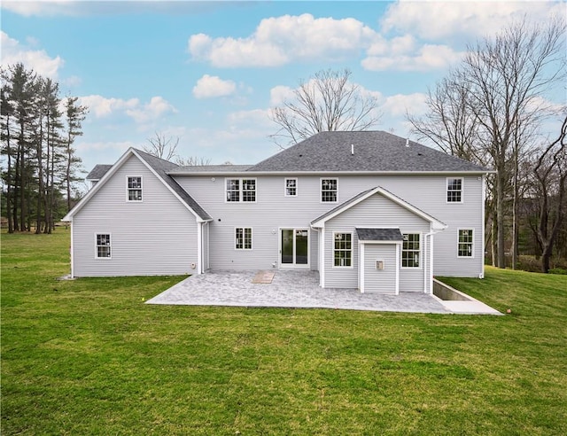 rear view of property with a yard and a patio