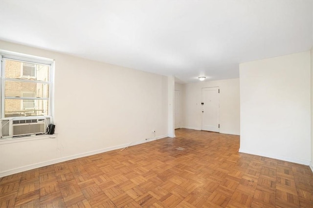 unfurnished room featuring cooling unit and light parquet flooring