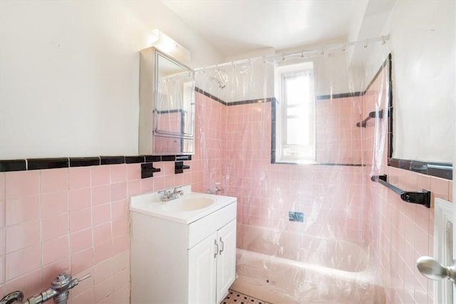 bathroom with shower / bath combination with curtain, vanity, and tile walls