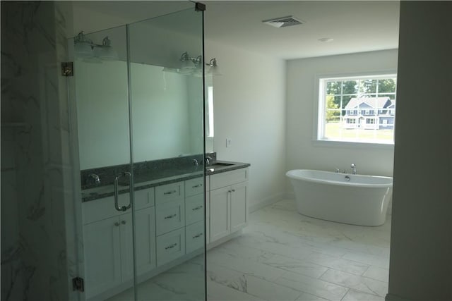 bathroom featuring vanity and independent shower and bath