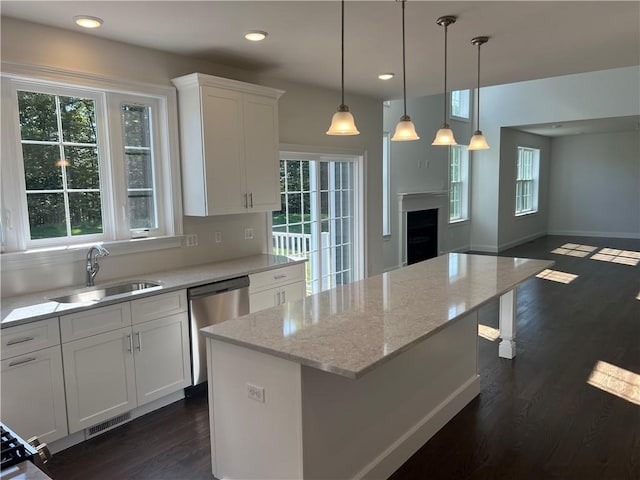 kitchen with white cabinets, plenty of natural light, dark hardwood / wood-style flooring, and sink