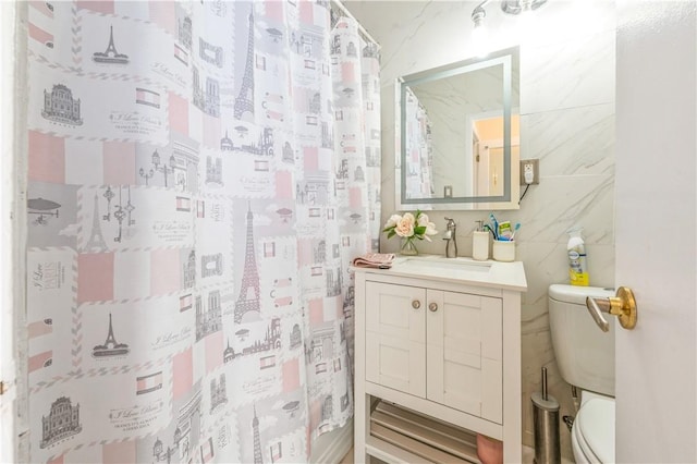 bathroom featuring vanity, toilet, and curtained shower