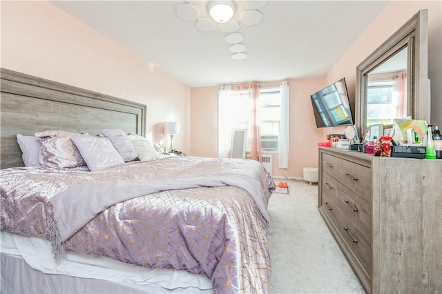 bedroom with multiple windows, ceiling fan, and light colored carpet