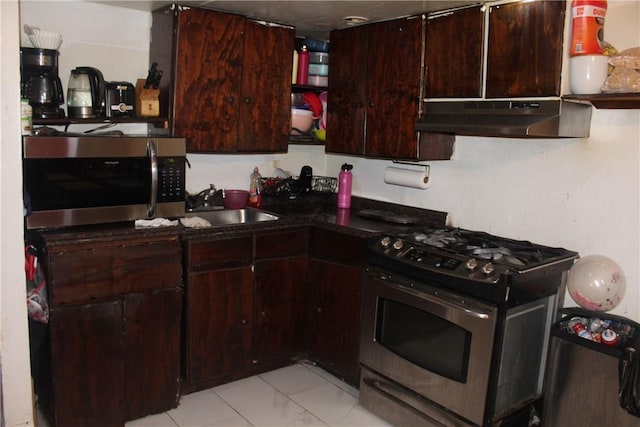 kitchen with dark brown cabinets and appliances with stainless steel finishes