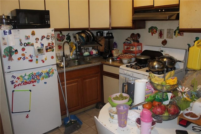 kitchen with sink, light tile patterned floors, and white appliances