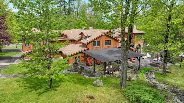 view of front of home with a patio area and a front lawn