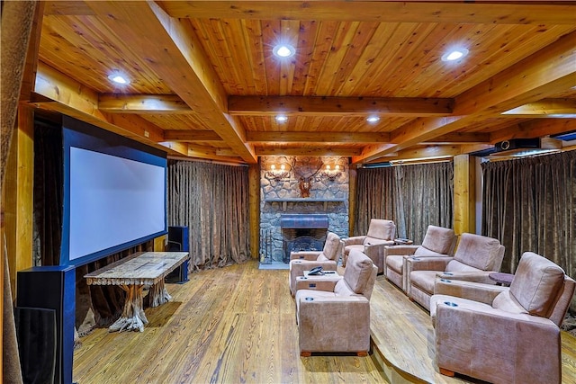 cinema room featuring wood ceiling, a fireplace, beamed ceiling, and light hardwood / wood-style floors