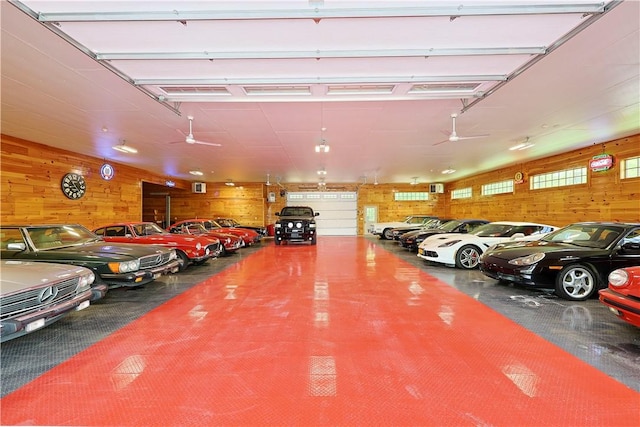 garage with ceiling fan and wood walls