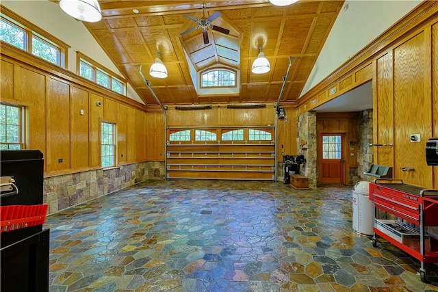 garage with wooden walls, ceiling fan, and wood ceiling