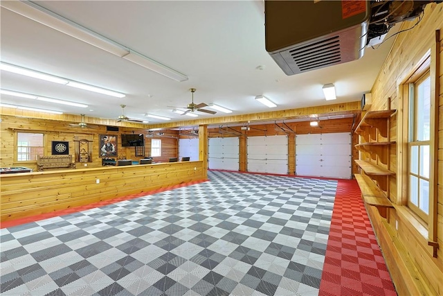 garage with wooden walls and ceiling fan