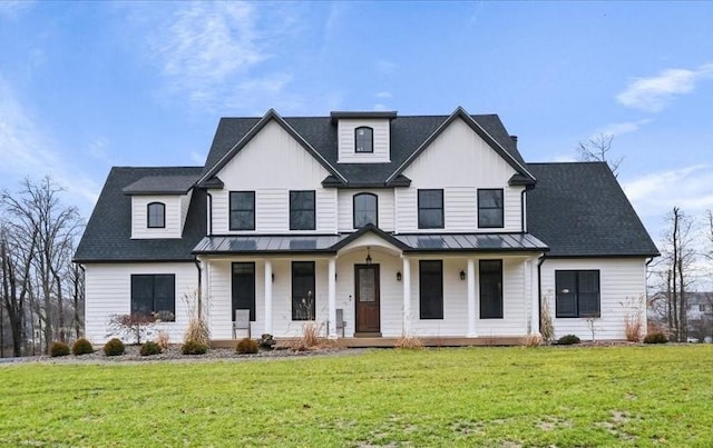 modern farmhouse with a front yard and a porch