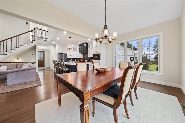 dining room featuring dark hardwood / wood-style floors, a notable chandelier, and sink