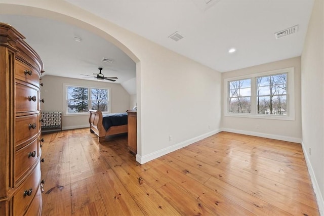 bedroom with ceiling fan, light hardwood / wood-style flooring, and vaulted ceiling