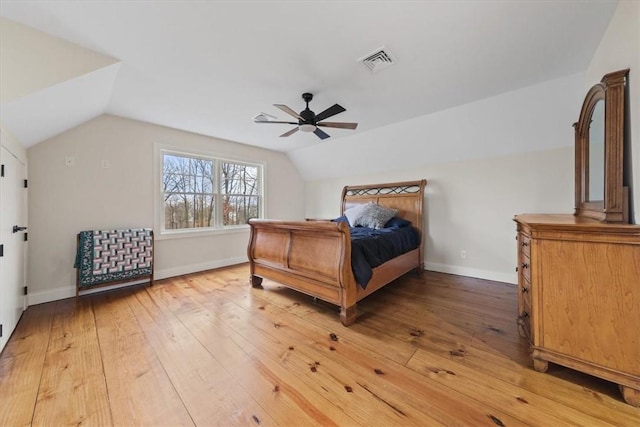 bedroom with ceiling fan, wood-type flooring, and vaulted ceiling