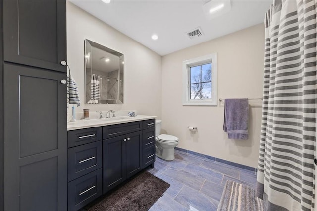 bathroom featuring vanity, curtained shower, and toilet