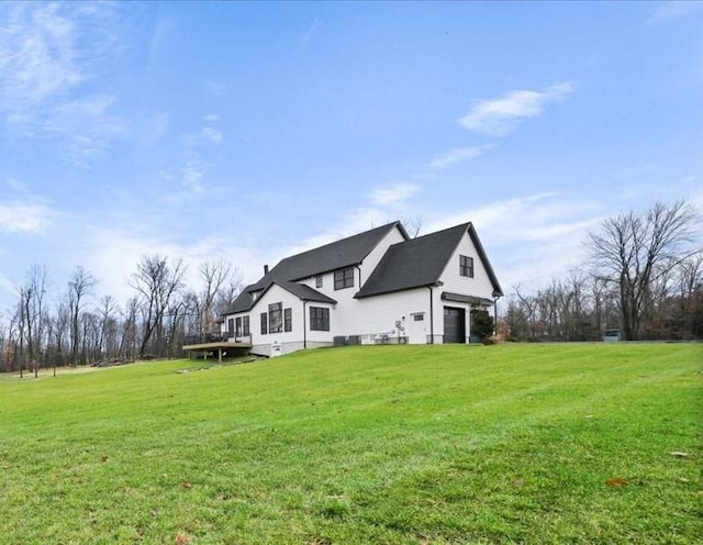 exterior space with a garage and a lawn