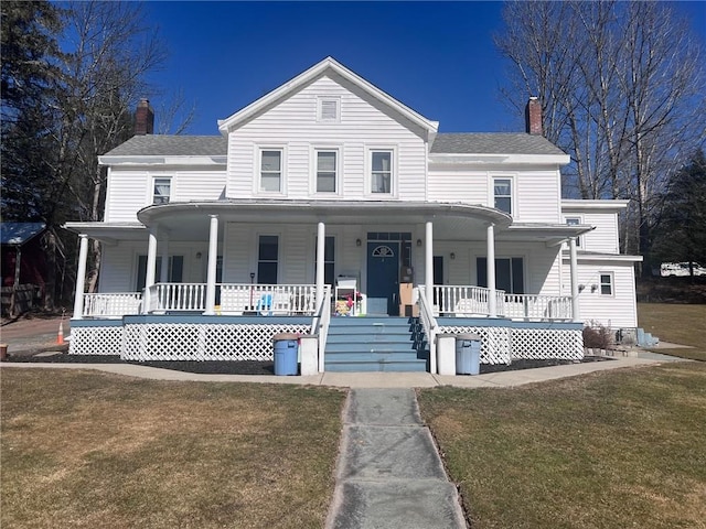 country-style home with a porch and a front lawn